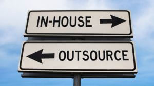 Outsource versus in-house road sign with two arrows on blue sky background. White two streets sign with arrows on metal pole. Directional sign.